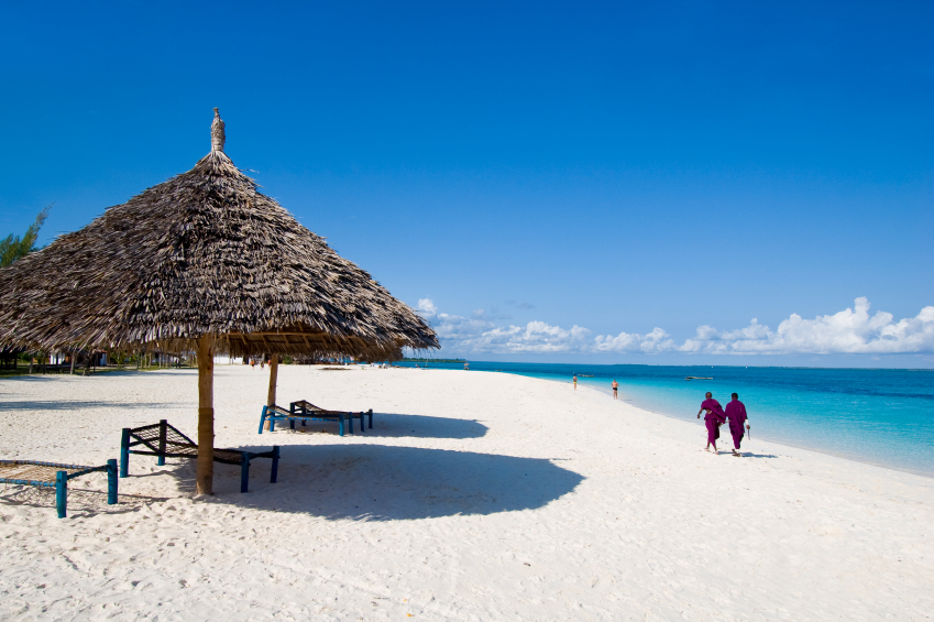 locals walking on beach in zanzibar